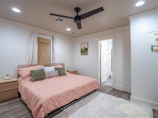 bedroom featuring ceiling fan, ornamental molding, and light hardwood / wood-style flooring