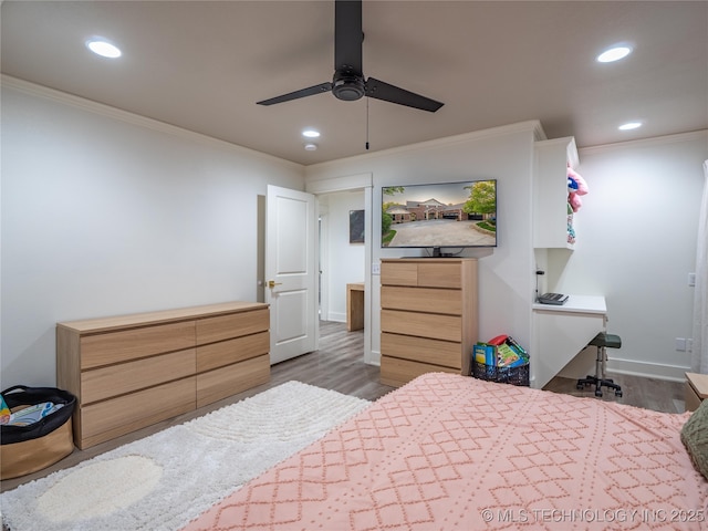 bedroom with dark hardwood / wood-style floors, ceiling fan, and ornamental molding