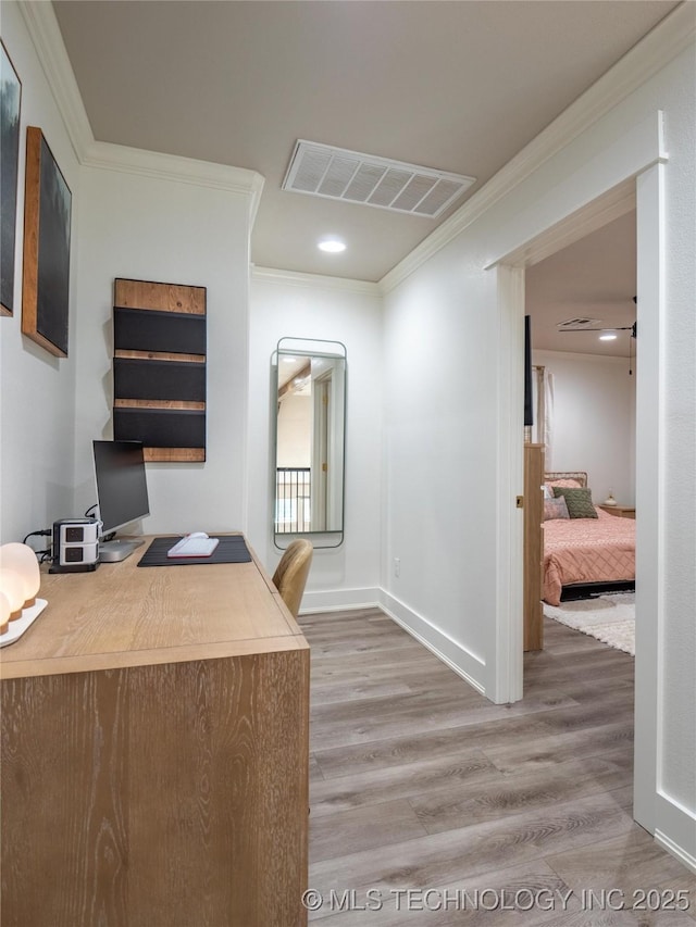 office area with wood-type flooring and crown molding