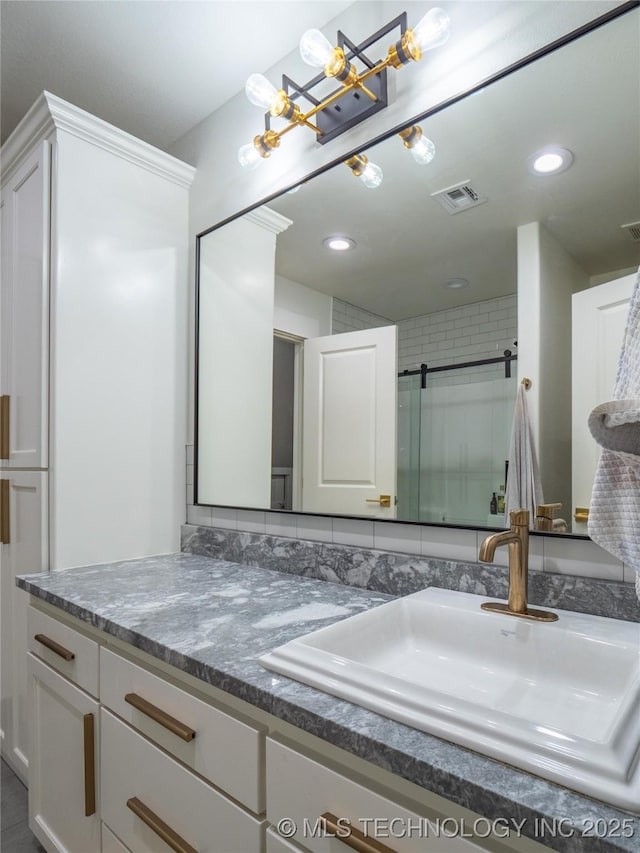 bathroom featuring vanity and a shower with shower door