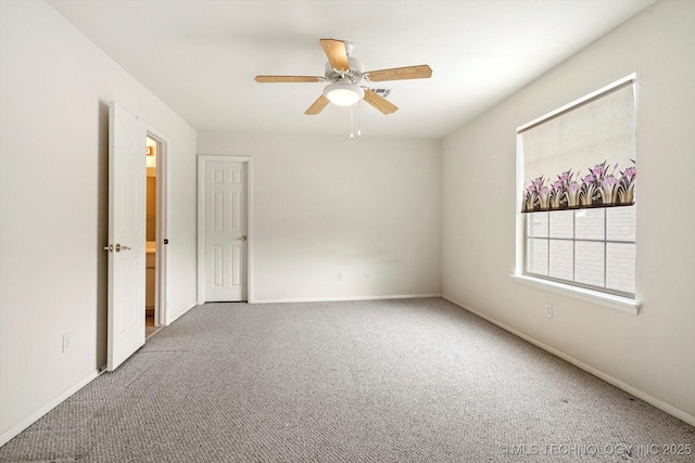 empty room featuring ceiling fan and carpet