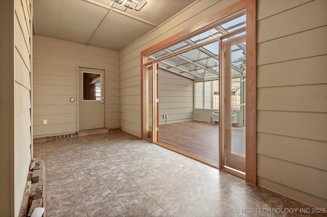 doorway with wood walls