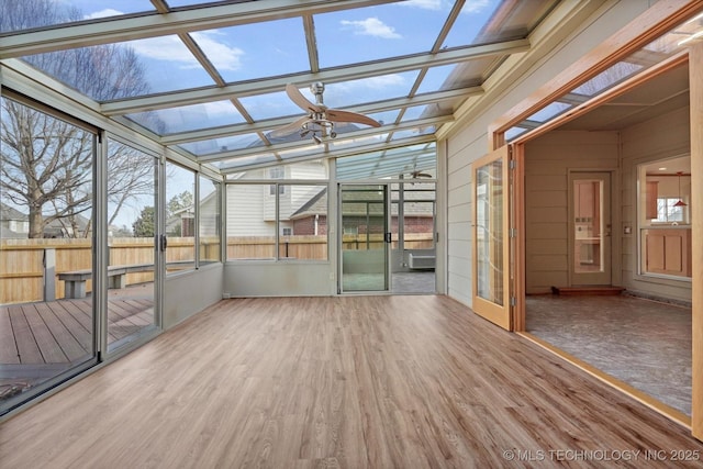 unfurnished sunroom featuring ceiling fan and lofted ceiling