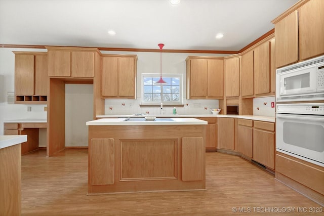 kitchen with crown molding, white appliances, light hardwood / wood-style flooring, and hanging light fixtures