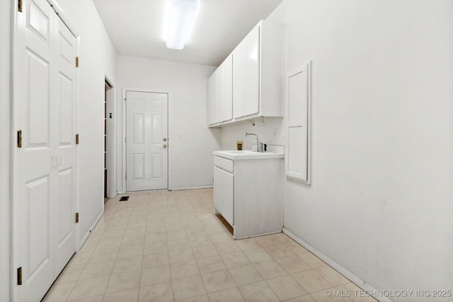 clothes washing area featuring washer hookup, cabinets, and sink