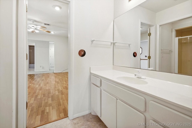 bathroom featuring ceiling fan, hardwood / wood-style flooring, and vanity