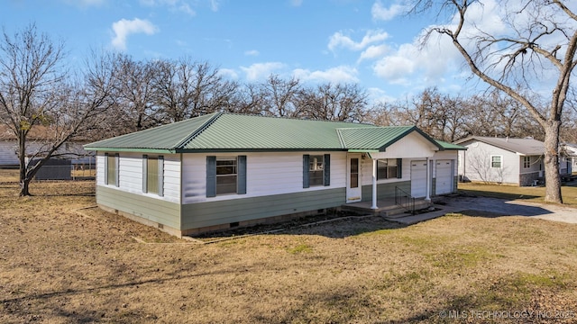 view of front of home featuring a garage and a front lawn