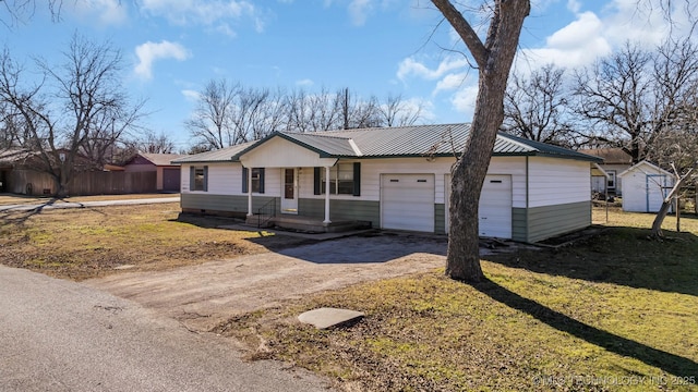 single story home featuring a garage and a front yard