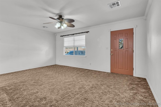 foyer with crown molding, ceiling fan, and carpet floors