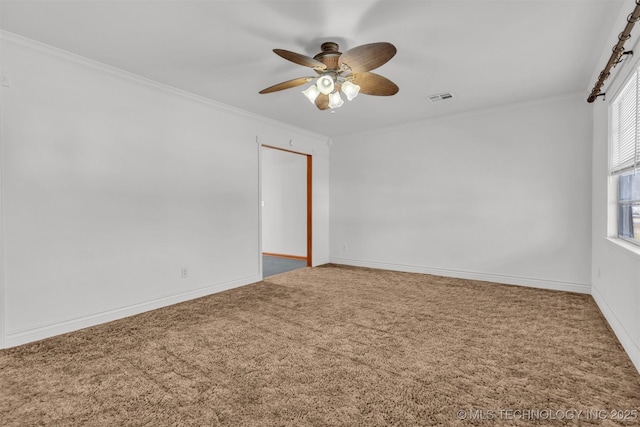 unfurnished room with crown molding, ceiling fan, and carpet flooring