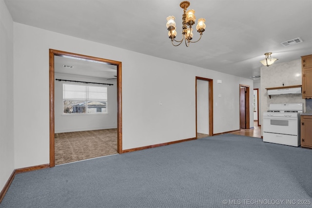 unfurnished living room featuring an inviting chandelier and light colored carpet