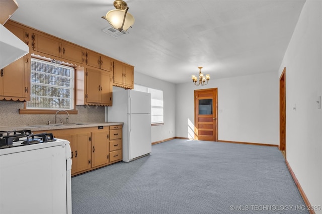 kitchen with extractor fan, sink, a chandelier, white appliances, and backsplash