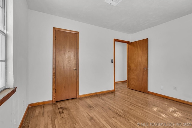 spare room featuring light hardwood / wood-style floors