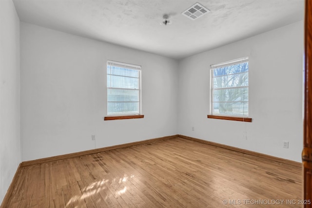 spare room with light hardwood / wood-style floors