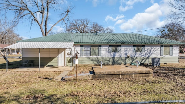 rear view of property featuring a patio and a lawn