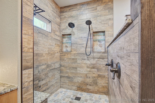 bathroom with tiled shower