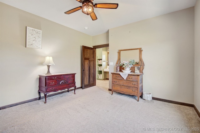 sitting room with ceiling fan and light carpet