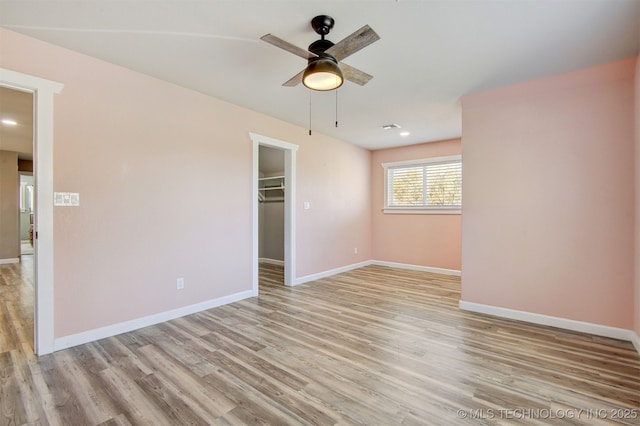 spare room featuring light hardwood / wood-style flooring and ceiling fan