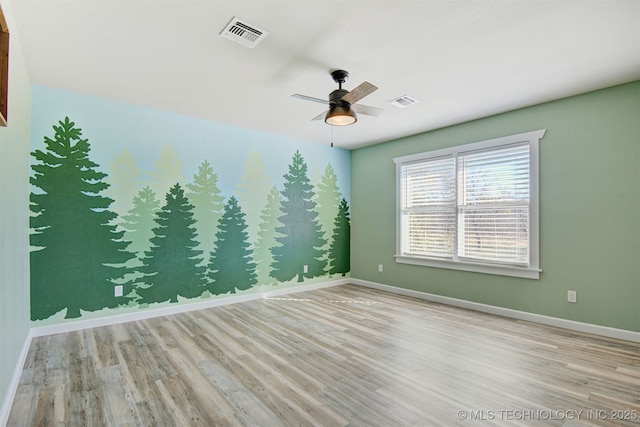 empty room featuring ceiling fan and light hardwood / wood-style flooring