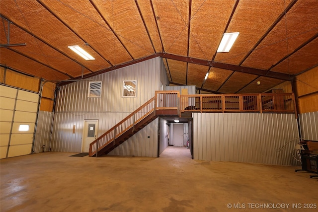 garage featuring wood walls