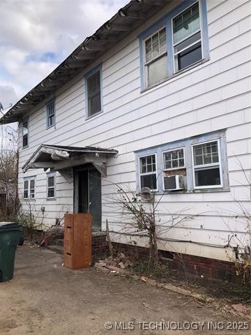 back of property featuring cooling unit