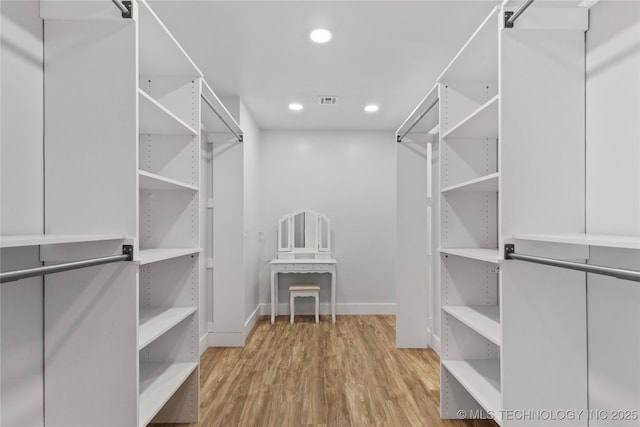 spacious closet with light hardwood / wood-style floors