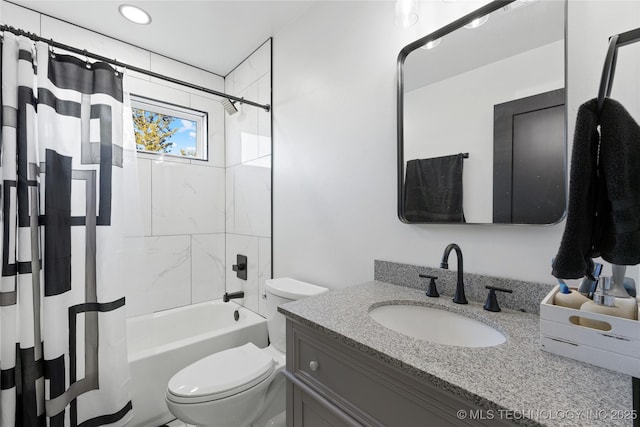 full bathroom featuring shower / bath combo, vanity, and toilet