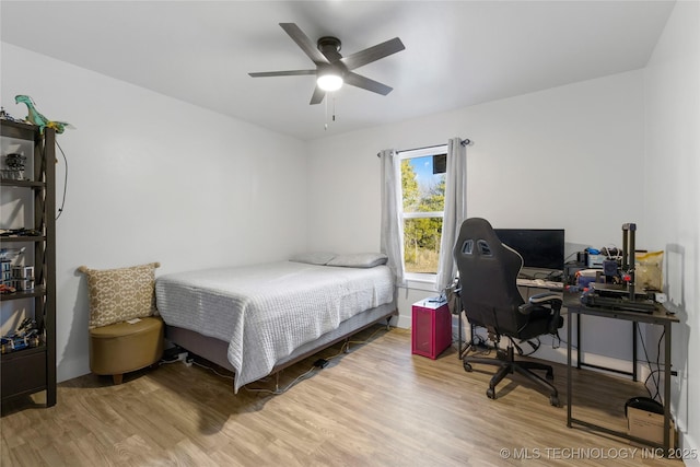 bedroom with ceiling fan and wood-type flooring