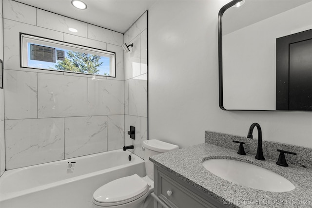 full bathroom featuring vanity, tiled shower / bath combo, and toilet