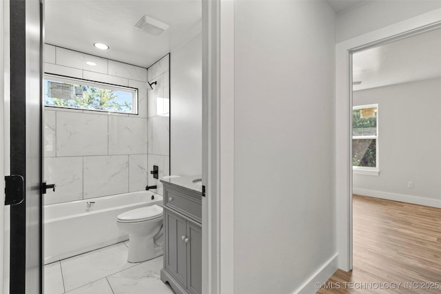 full bathroom with vanity, toilet, and tiled shower / bath combo