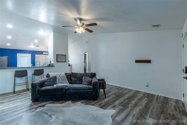 living room featuring a textured ceiling, ceiling fan, dark hardwood / wood-style floors, and sink