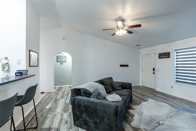 living room with ceiling fan, lofted ceiling, and hardwood / wood-style flooring