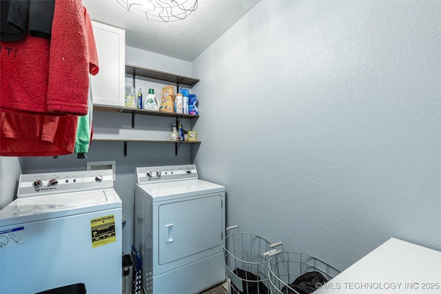 clothes washing area featuring separate washer and dryer and a textured ceiling