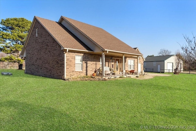 back of property with a lawn and a patio area