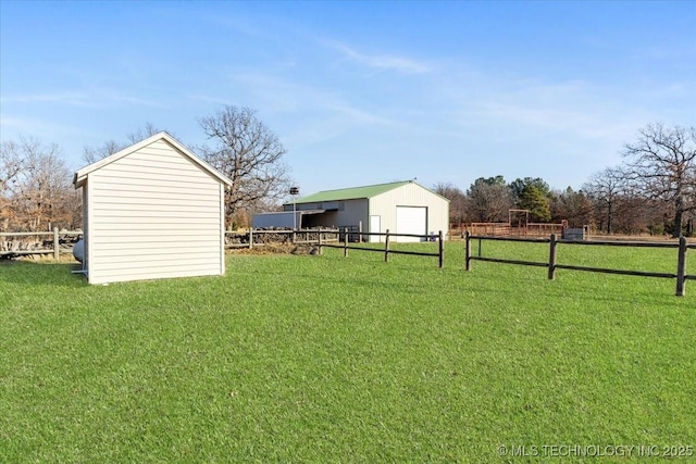 view of yard with an outbuilding and a rural view