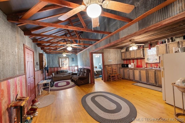 living room with light wood-type flooring and high vaulted ceiling