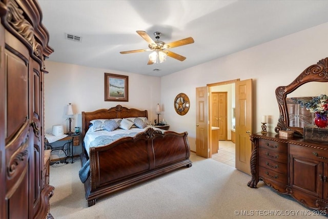 carpeted bedroom with ceiling fan and ensuite bathroom