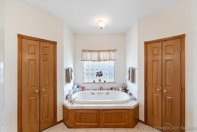 bathroom featuring tile patterned flooring and a washtub