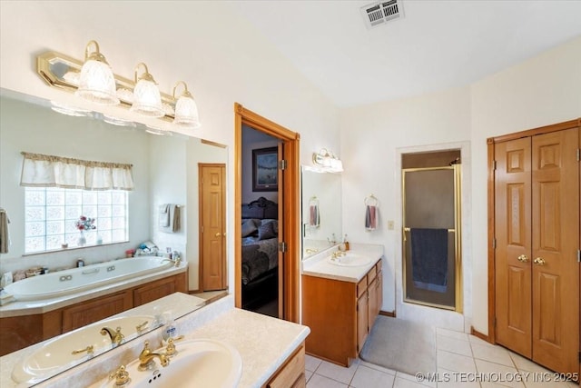 bathroom featuring tile patterned floors, separate shower and tub, and vanity