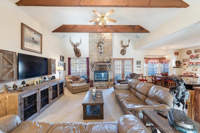 living room featuring high vaulted ceiling, ceiling fan, a fireplace, beamed ceiling, and light colored carpet