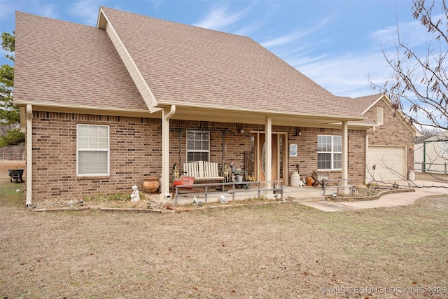 view of front of home featuring a garage, a porch, and a front yard