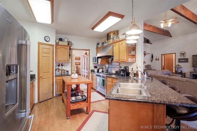 kitchen featuring appliances with stainless steel finishes, sink, kitchen peninsula, light wood-type flooring, and wall chimney exhaust hood