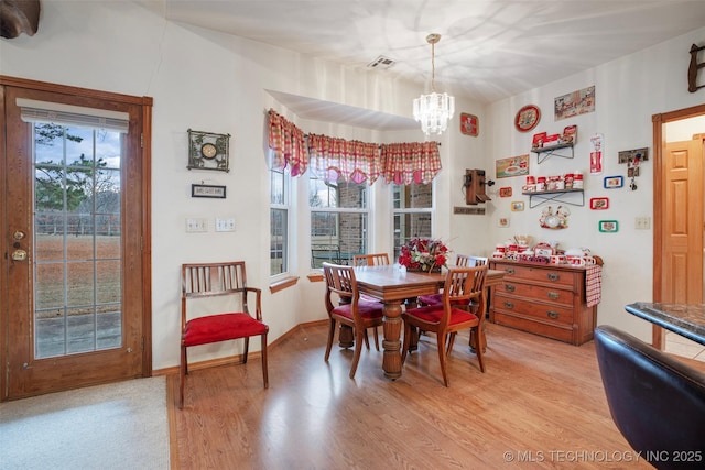 dining area with a chandelier and light wood-type flooring