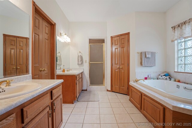 bathroom featuring tile patterned flooring, vanity, and separate shower and tub