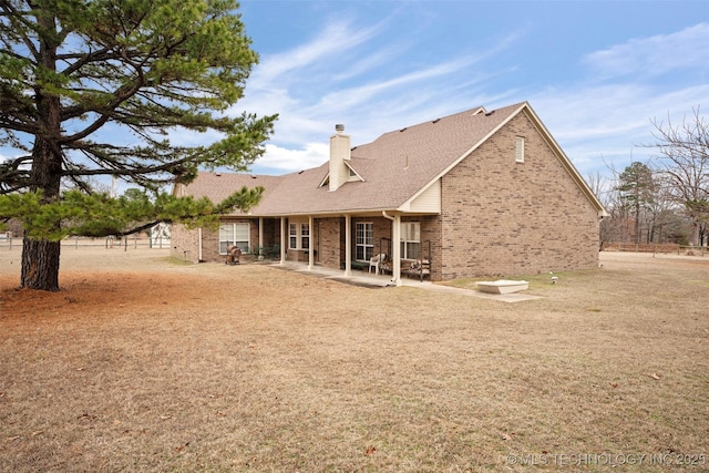 rear view of property featuring a patio area