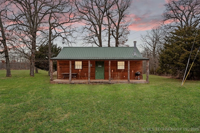 outdoor structure at dusk featuring a lawn