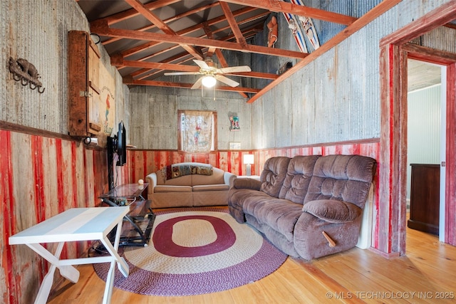 living room featuring hardwood / wood-style flooring, high vaulted ceiling, and ceiling fan