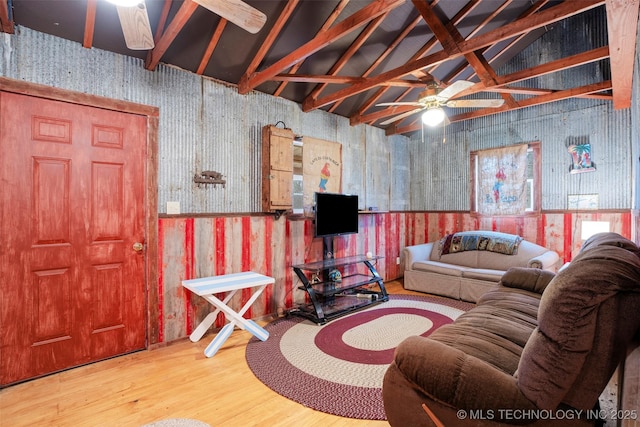 living room with wood-type flooring, lofted ceiling, and ceiling fan