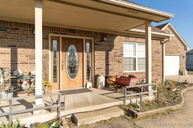 property entrance with a garage and covered porch