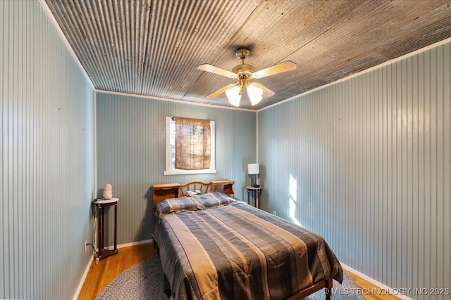 bedroom featuring crown molding, ceiling fan, and light hardwood / wood-style flooring